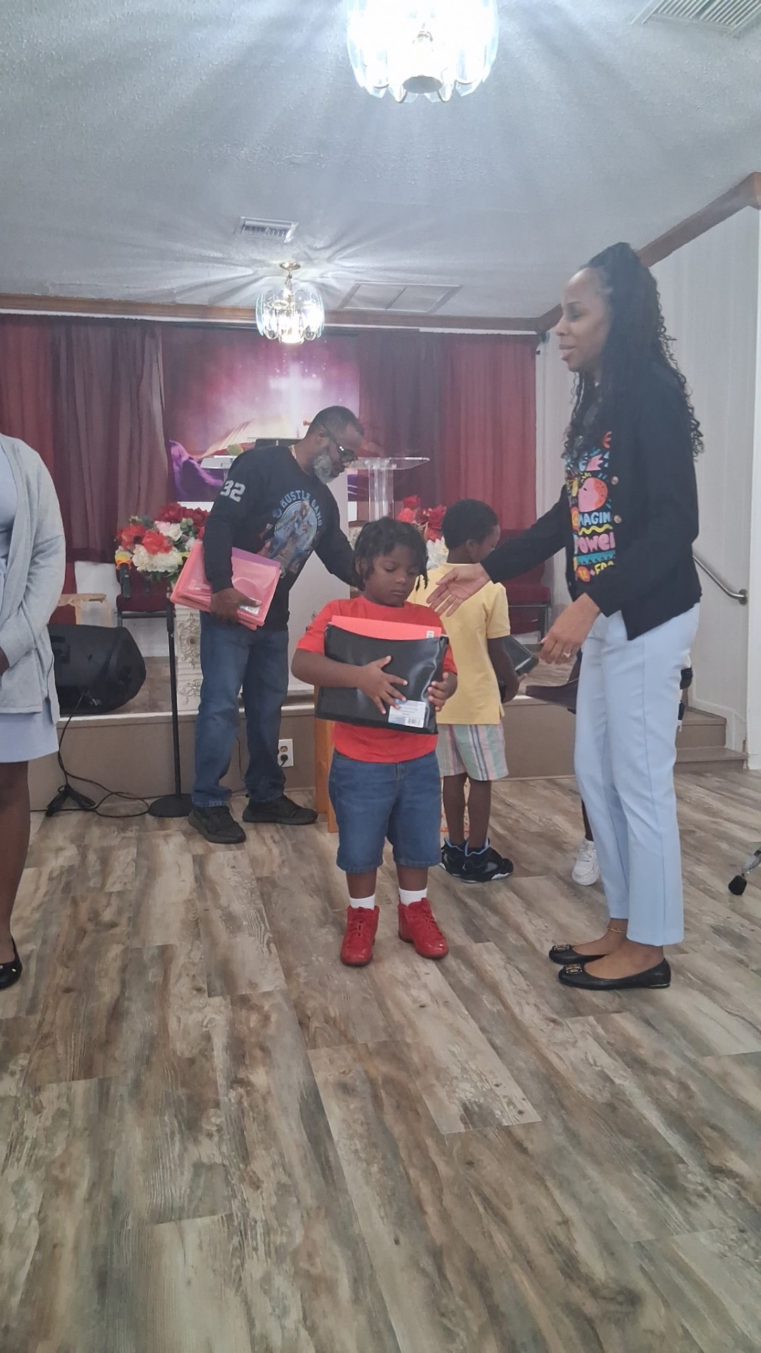Children receiving supplies at the ministry's back-to-school giveaway